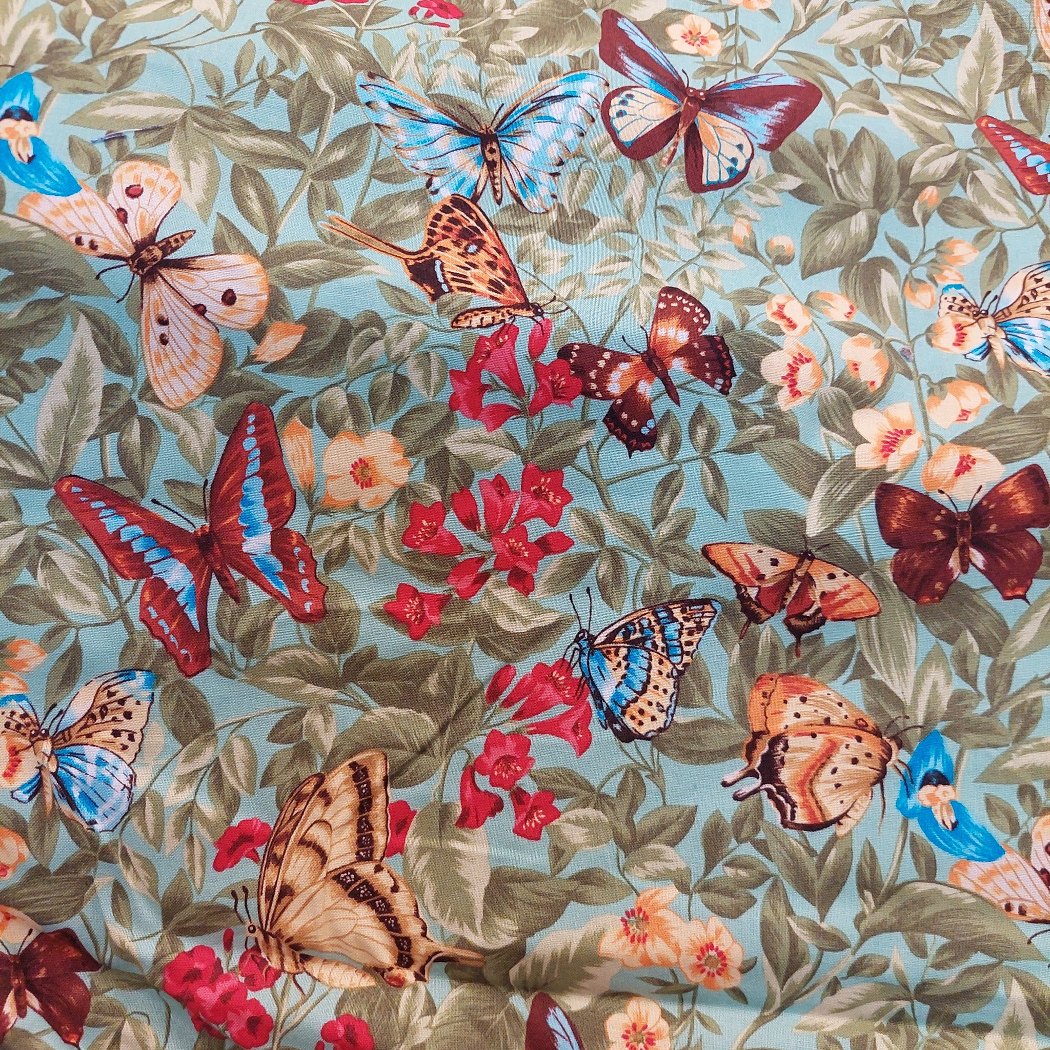 Butterflies on green cotton fabric by  Hancock Fabrics