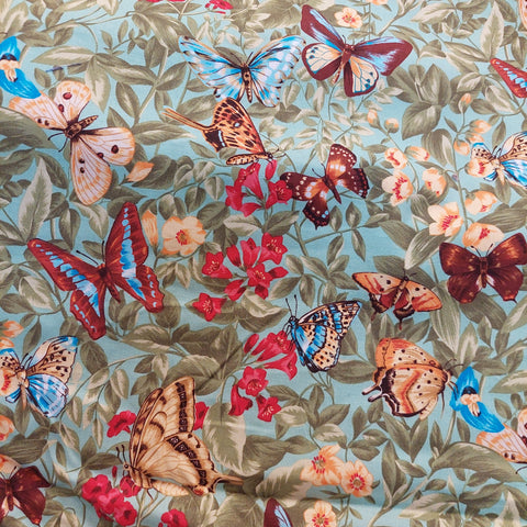 Butterflies on green cotton fabric by  Hancock Fabrics